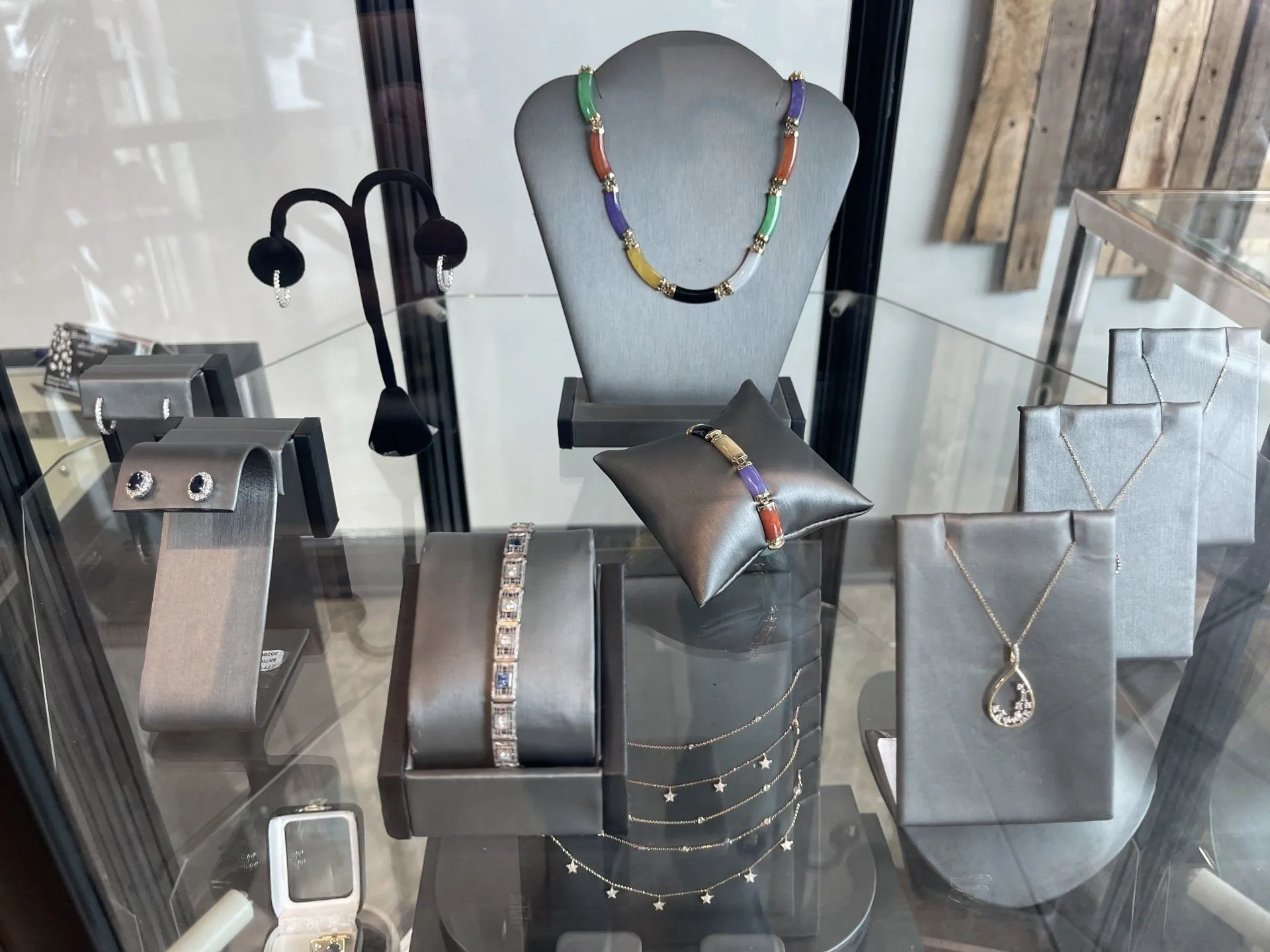 Showroom case of multi-colored gemstone necklaces and bracelets