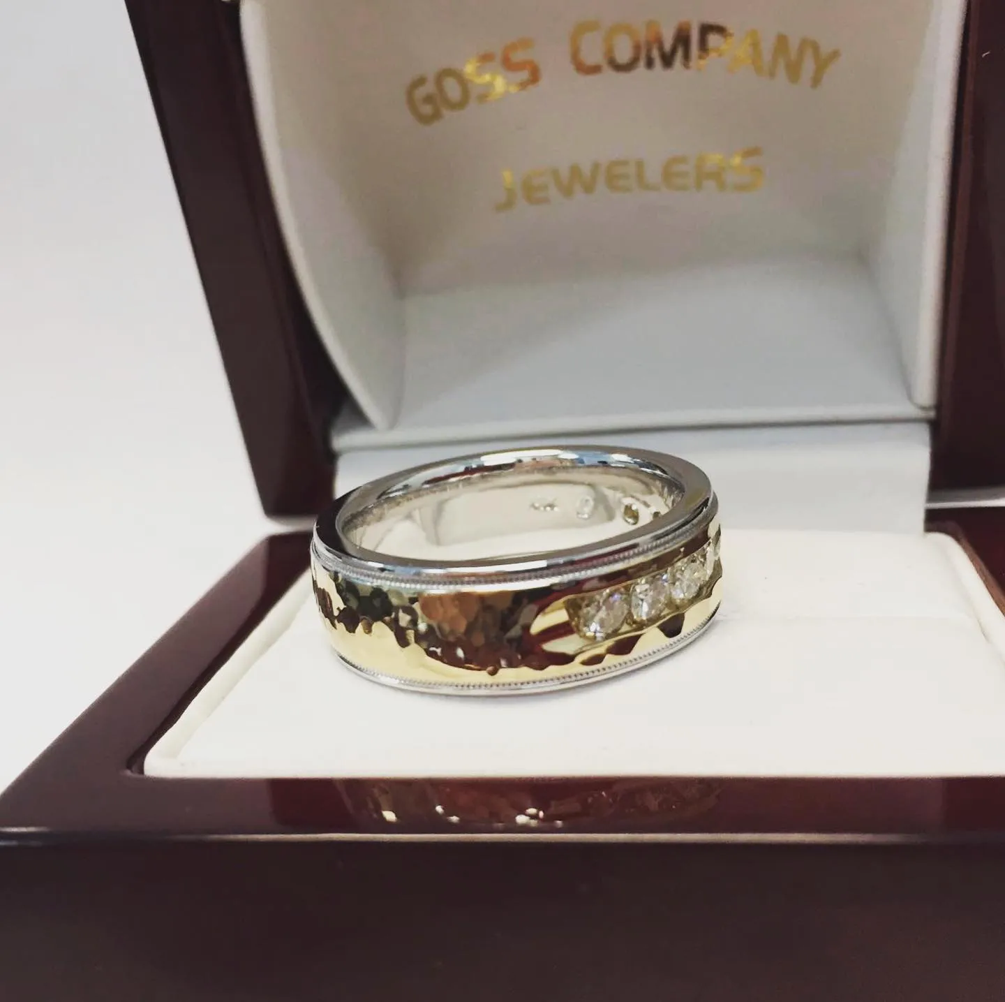 Custom hammered men's band with channel-set diamonds in a Goss Company Jewelers box